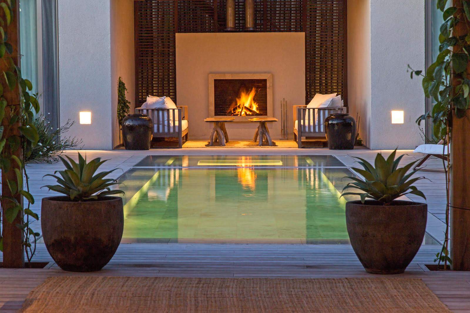 Private residence at dusk with pool and open fire
