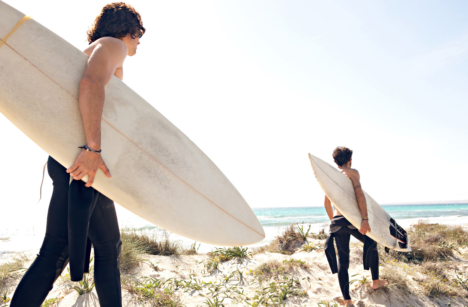 Two surfers walking to the break